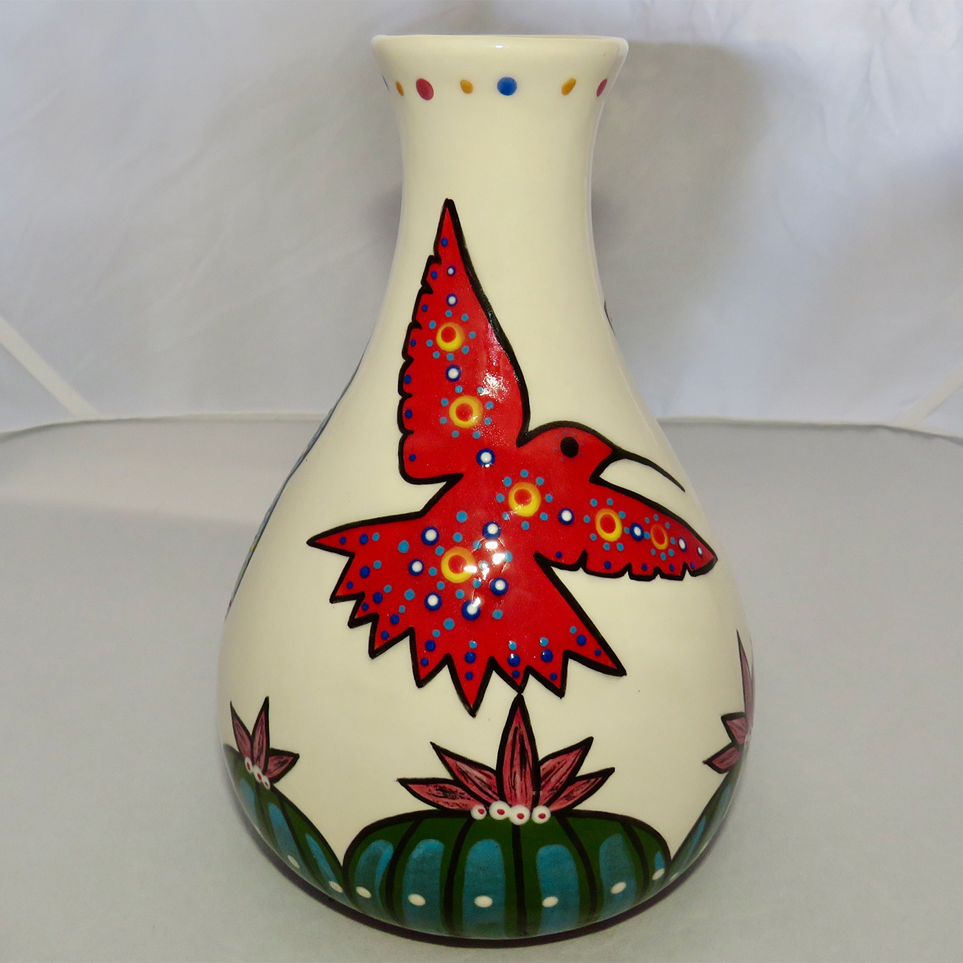 Mana Pottery Teardrop Vase featuring a blue, red and yellow hummingbird hovering above Peyote.