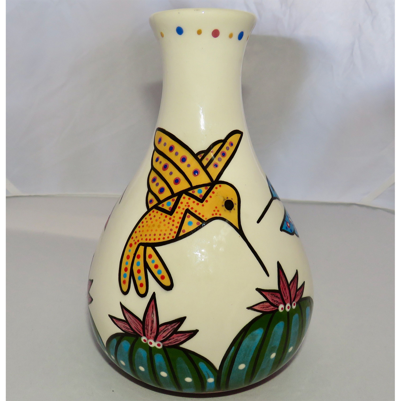 Mana Pottery Teardrop Vase featuring a blue, red and yellow hummingbird hovering above Peyote.