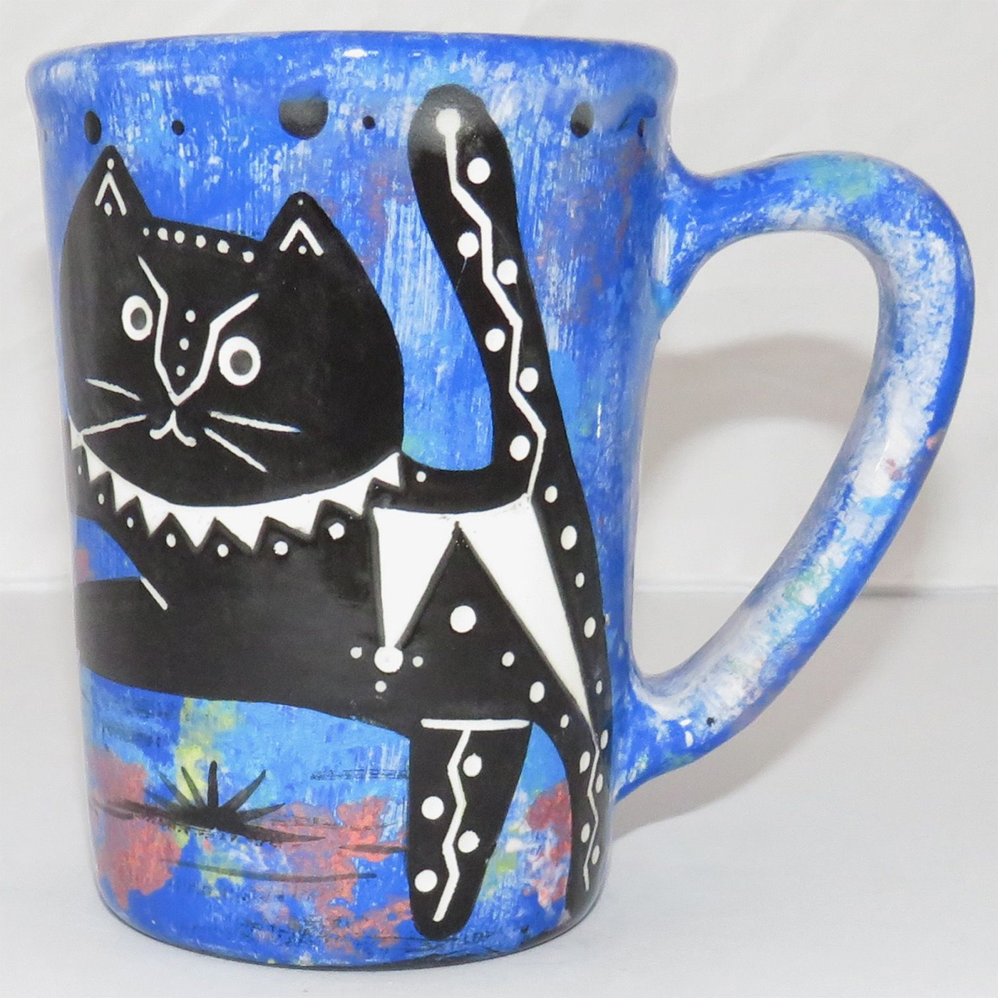 Mana Pottery large mug featuring kitty and desert veg on opposite sides on a blue background