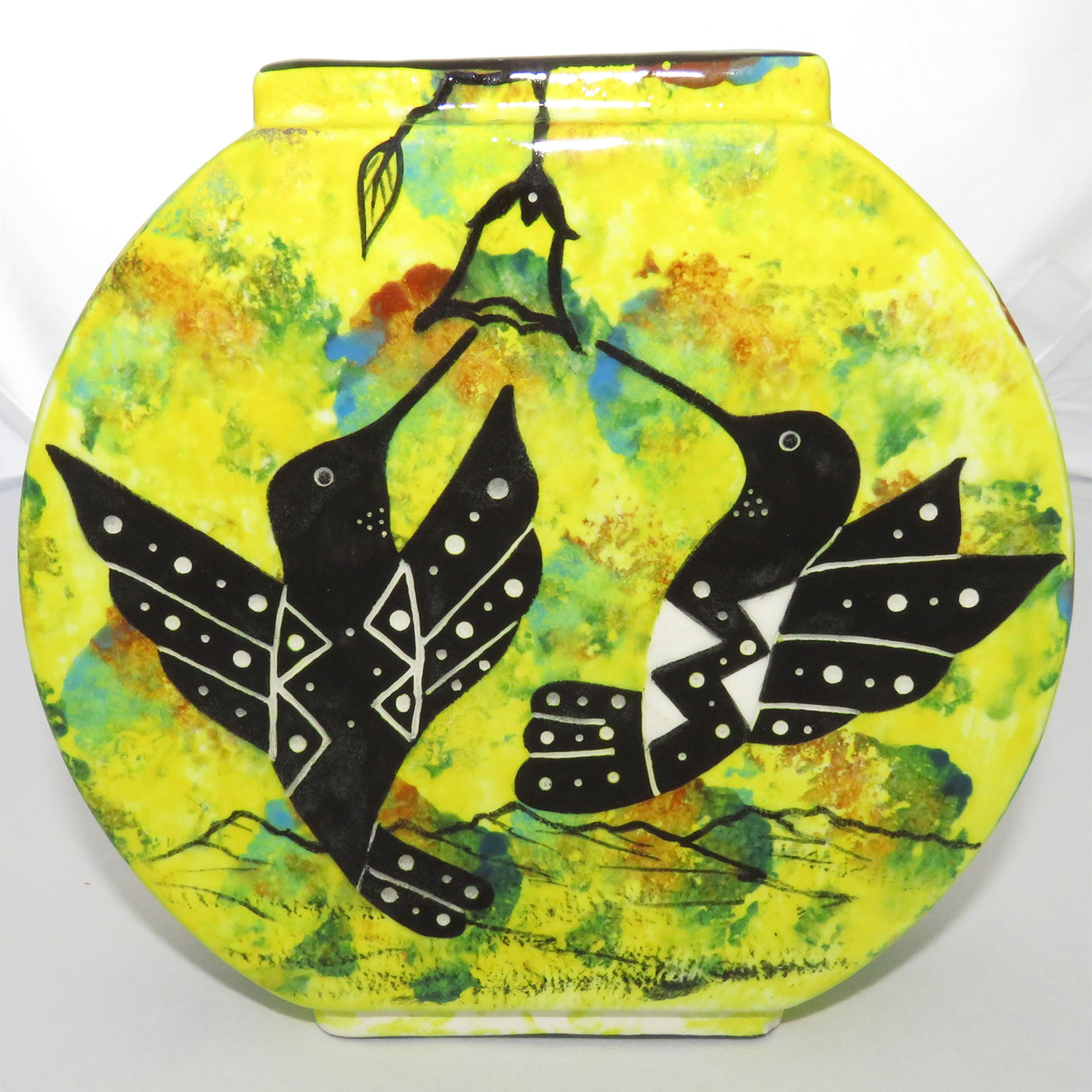 Mana Pottery Pillow Vase with hummingbirds and butterfly on reverse sides on a bright yellow background