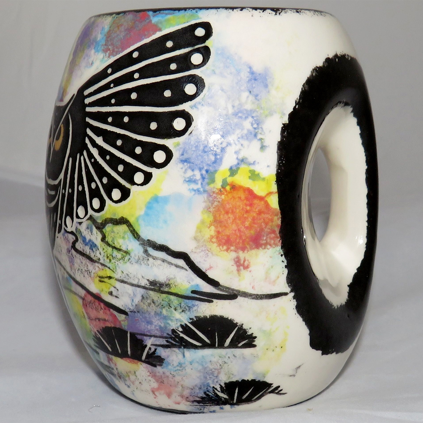 Mana Pottery Owl Mug. Owl face on handle side and owl in flight on opposite side. Side showing handle.