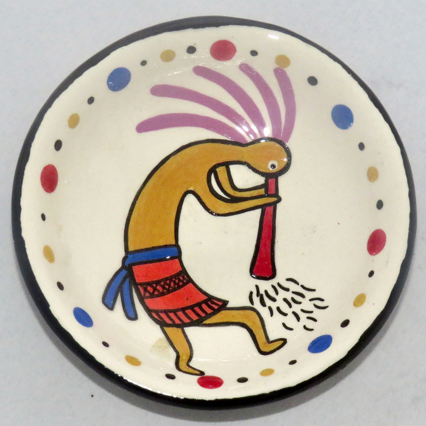 Image of Mana Pottery Holy Bowl featuring Kokopelli, and black and white marbled underside.