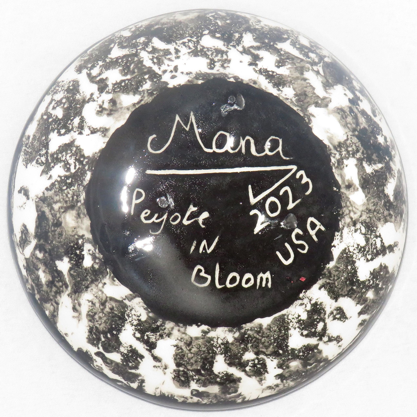 Mana Pottery Holy Bowl featuring large Peyote button design, with black and white marbled underside. This view shows the underside.