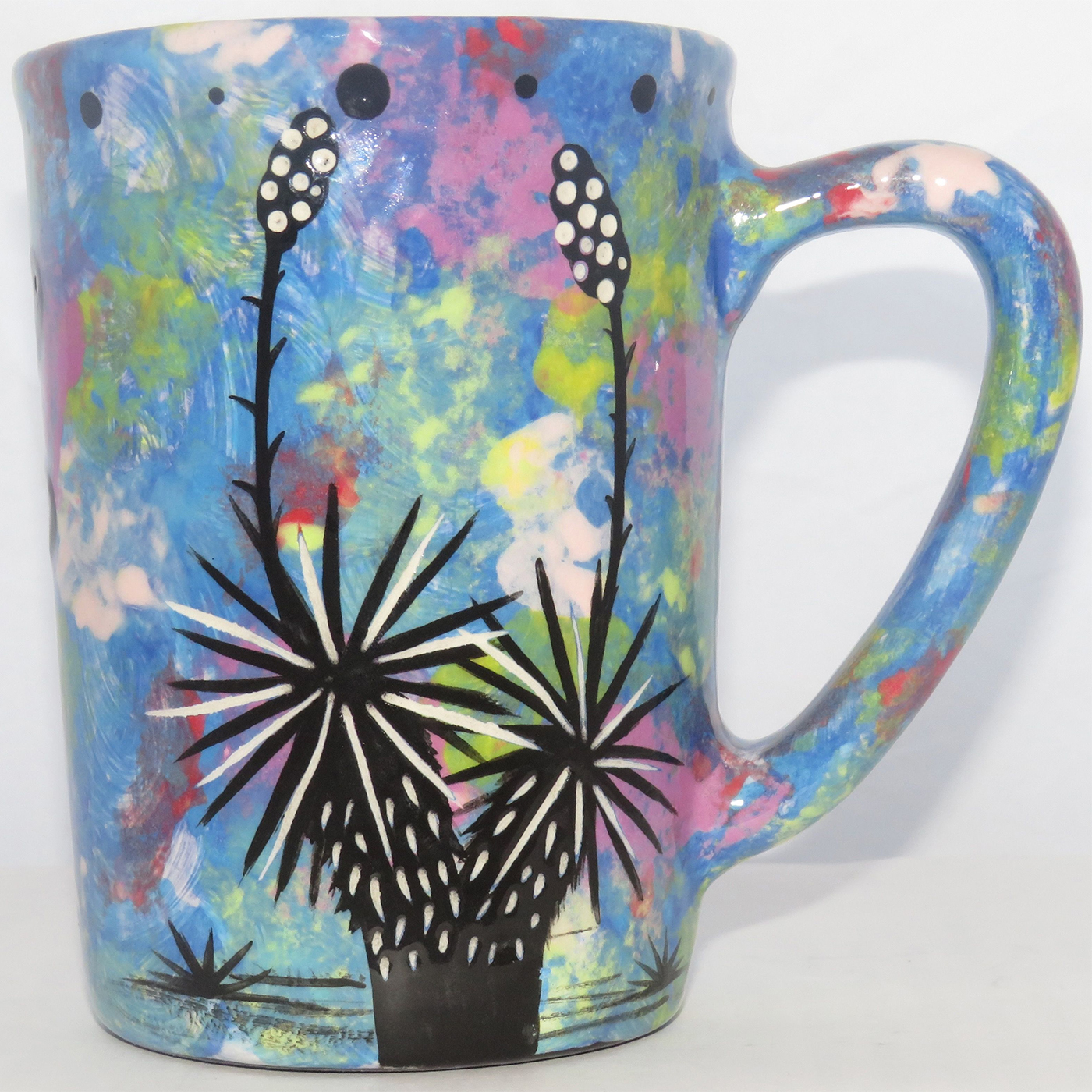 Mana Pottery large mug featuring dragonfly and desert scene on opposite sides on a blue background.