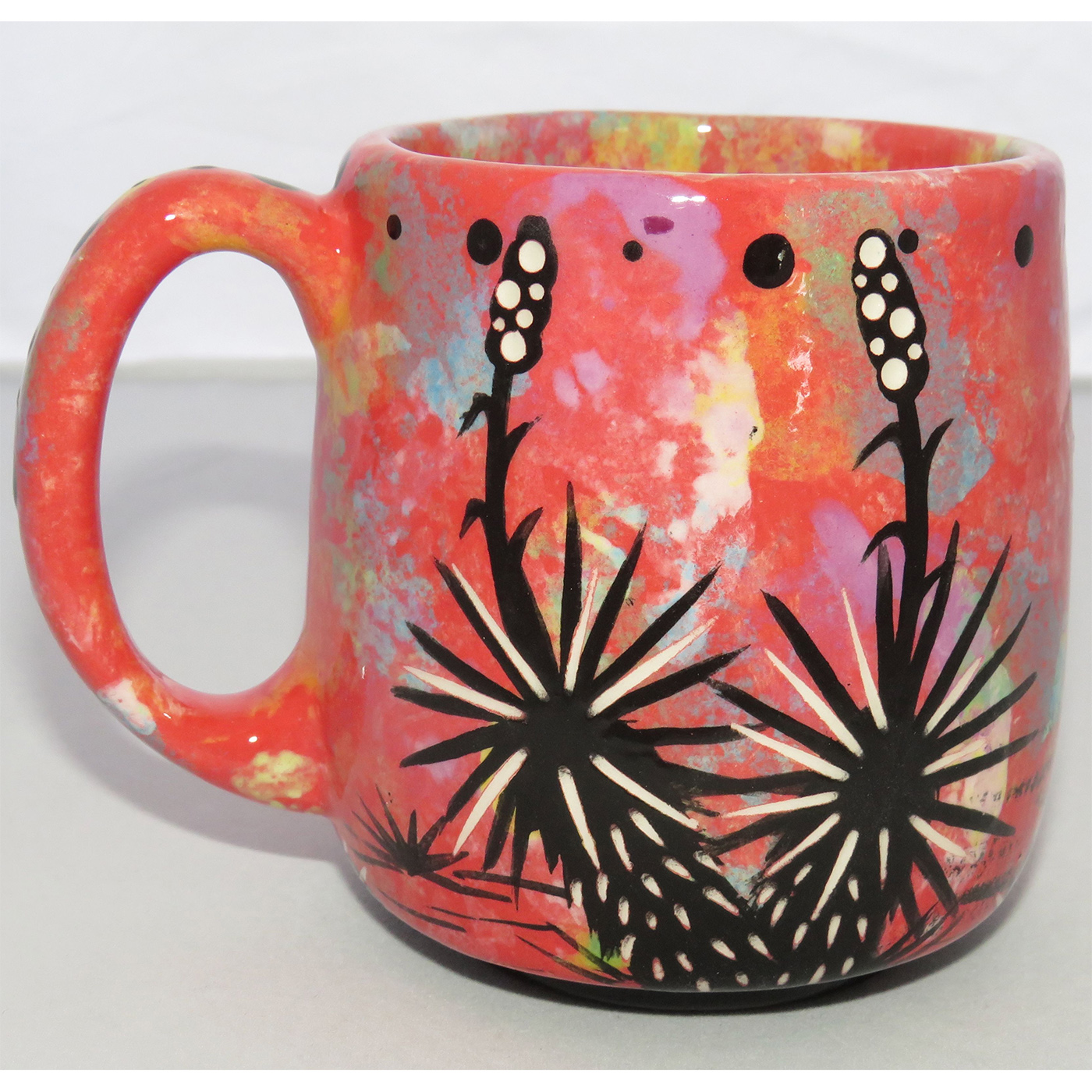 Photo of Mana Pottery Country Cup featuring a running deer in the desert, on a rose background.