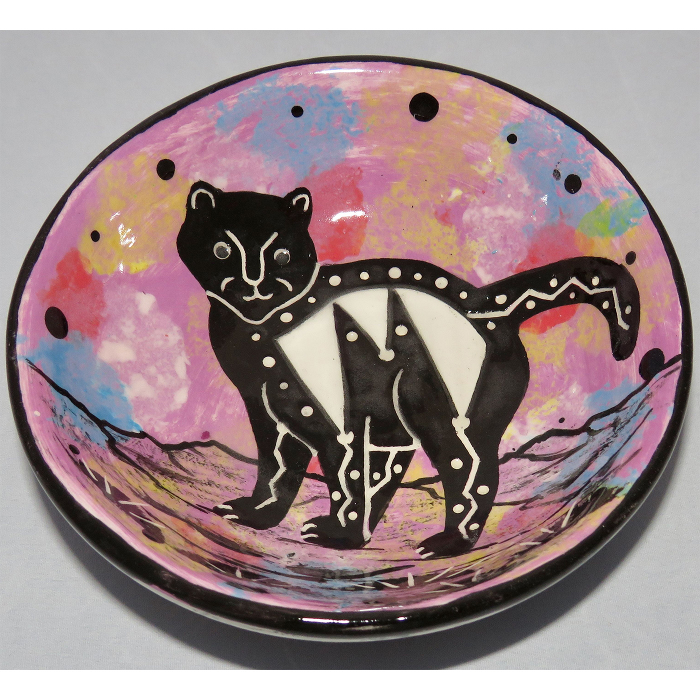Photo of Mana Pottery Five Inch Bowl featuring kitty in desert, on lavender background.