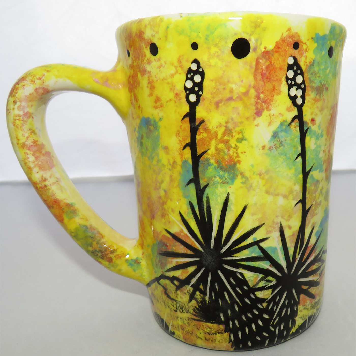 Photo of Mana Pottery Large Mug featuring hawk in flight over desert on a bright yellow background.