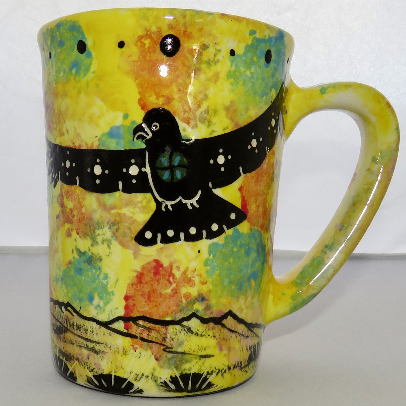 Photo of Mana Pottery Large Mug featuring hawk in flight over desert on a bright yellow background.