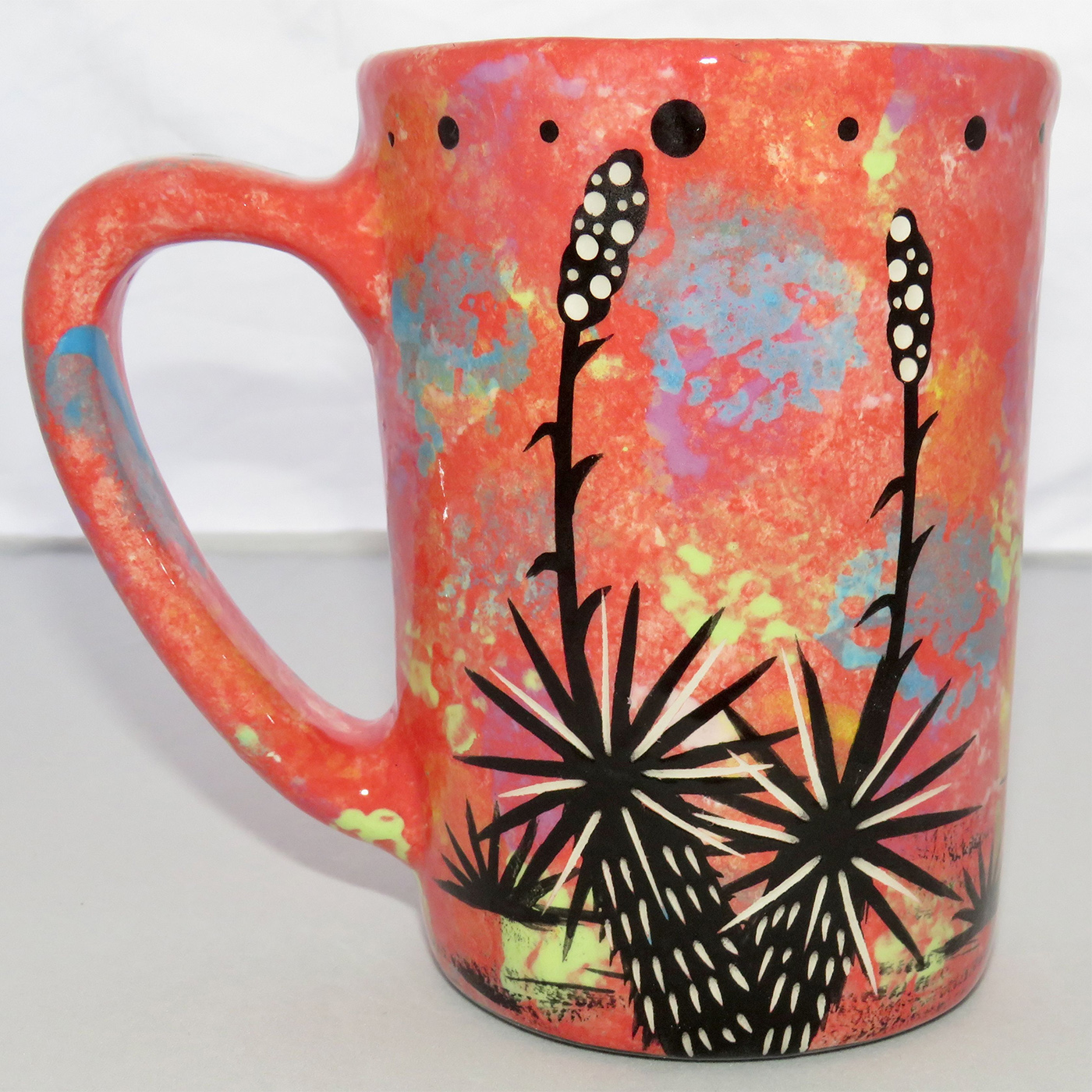 Photo of Mana Pottery Large Mug featuring quail family in desert on a rose background.
