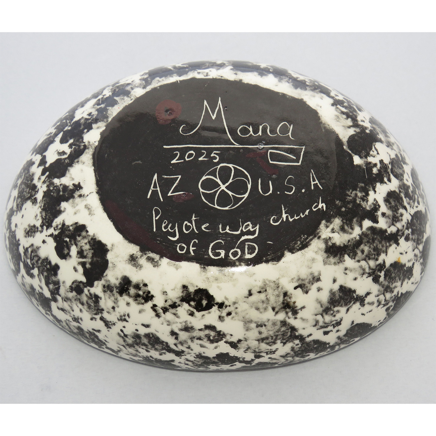 Photo of Mana Pottery Oval Bowl featuring hawk in flight high over desert, with multicolored underside.
