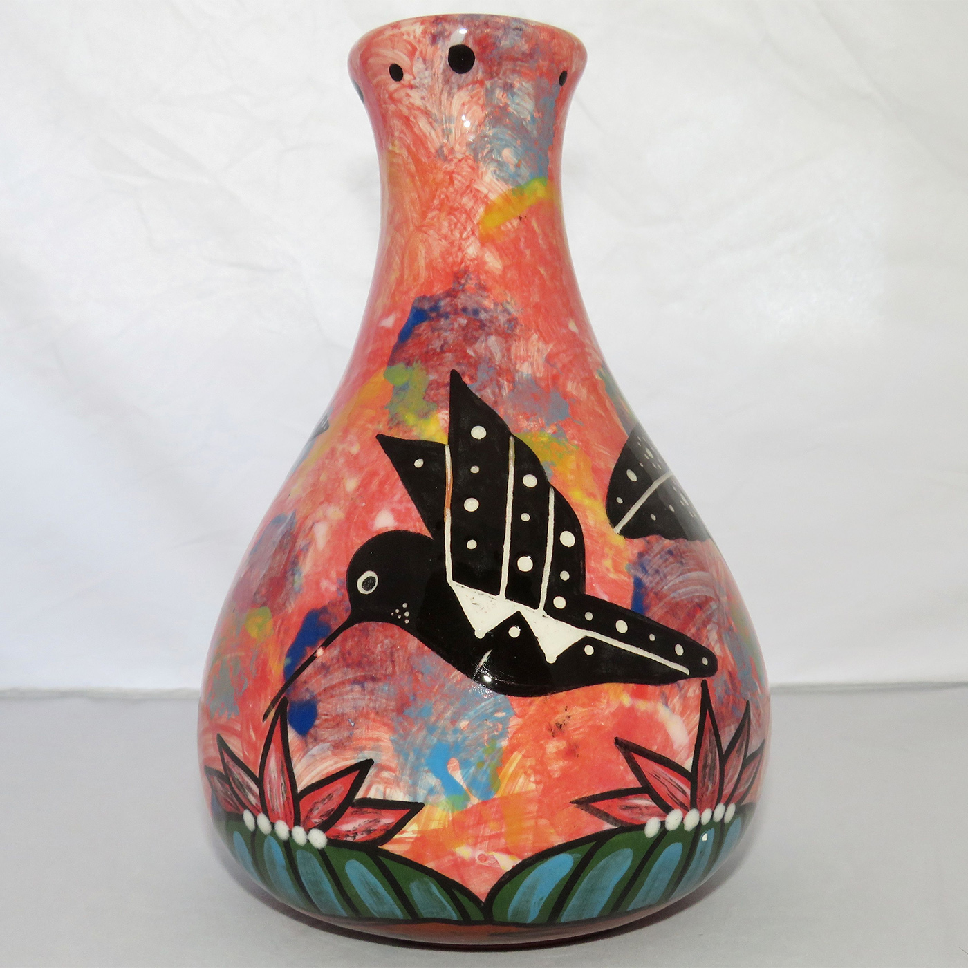 Photo of Mana Pottery Teardrop Vase featuring two hummingbirds and a butterfly over a Peyote grove, on a rose background.