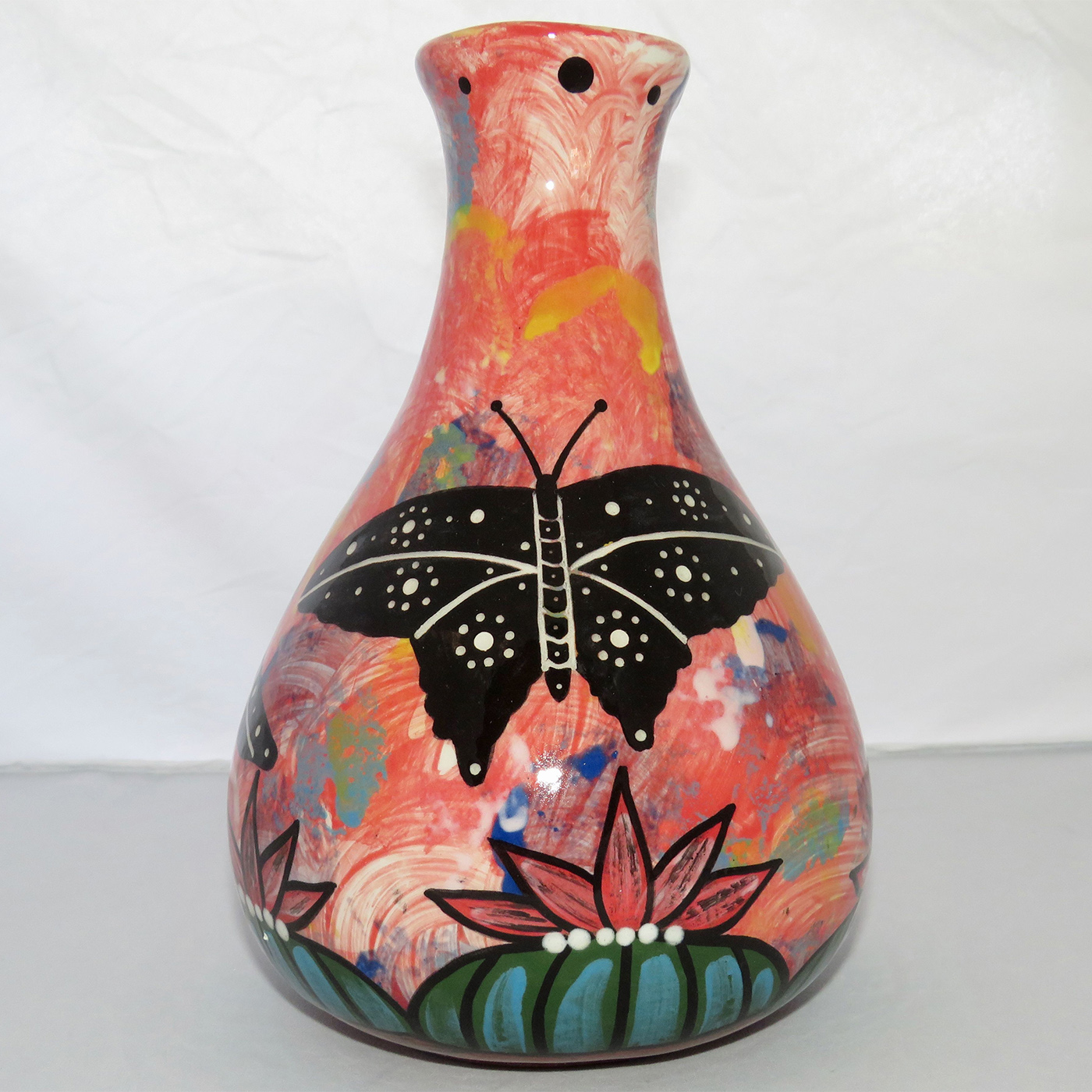 Photo of Mana Pottery Teardrop Vase featuring two hummingbirds and a butterfly over a Peyote grove, on a rose background.