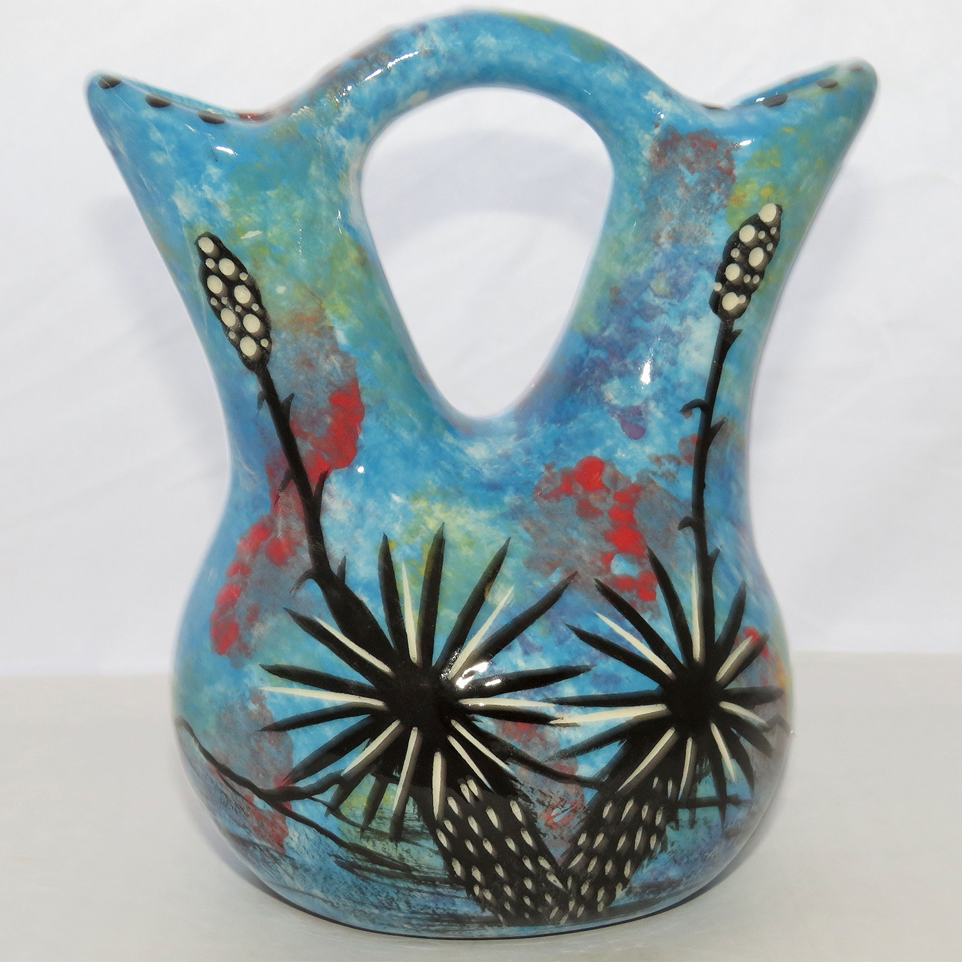 Image of Mana Pottery Tiny Wedding Vase featuring hawk in flight high in the sky on one side, and desert cactuses on reverse, all on a background of turquoise blue