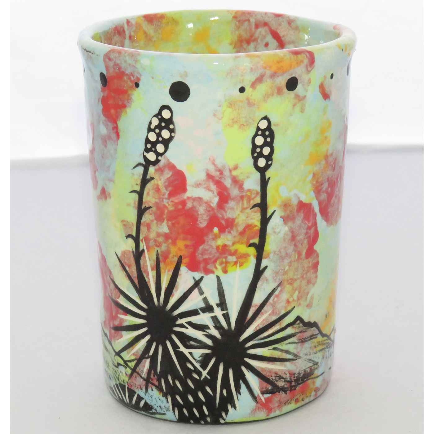 Photo of Mana Pottery Five Inch Tumbler featuring owl and desert plants on reverse sides, on a background of pale blue-green.