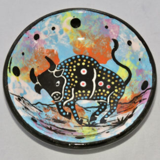 Photo of Mana Pottery Holy Bowl featuring bull on turquoise background, and black and white marbled underside.