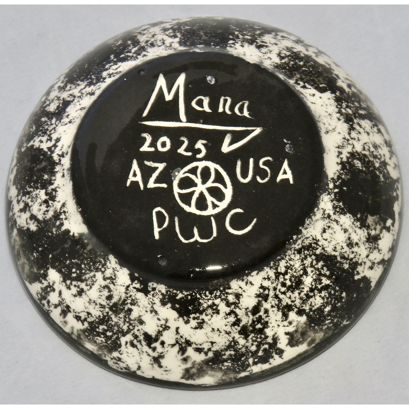 Photo of Mana Pottery Holy Bowl featuring bull on turquoise background, and black and white marbled underside.
