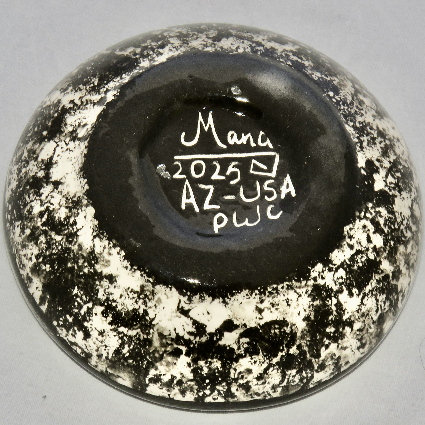 Photo of Mana Pottery Holy Bowl featuring deer on turquoise background, and black and white marbled underside.
