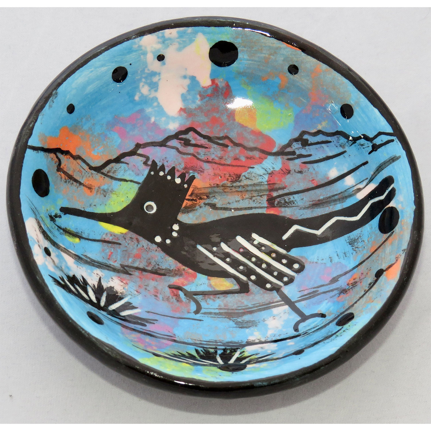 Photo of Mana Pottery Holy Bowl featuring roadrunner on turquoise background, and black and white marbled underside.