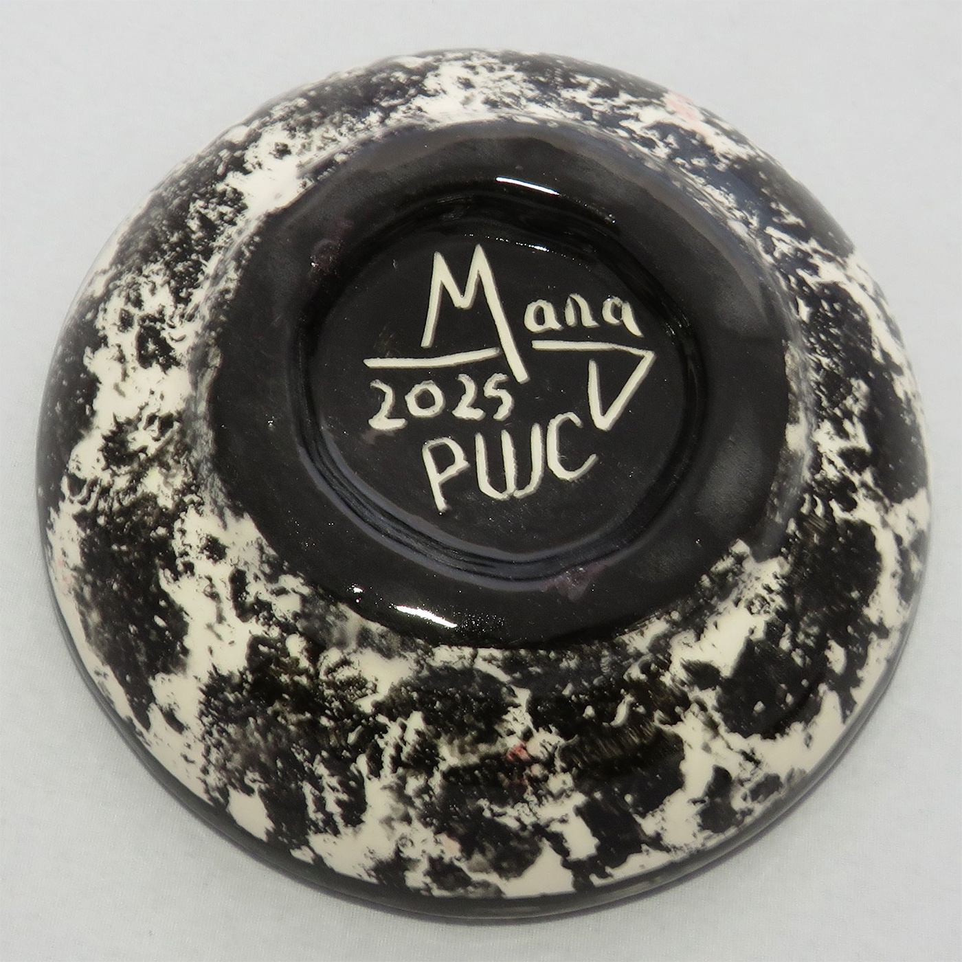 Photo of Mana Pottery Holy Bowl featuring toad on rose background, and black and white marbled underside.