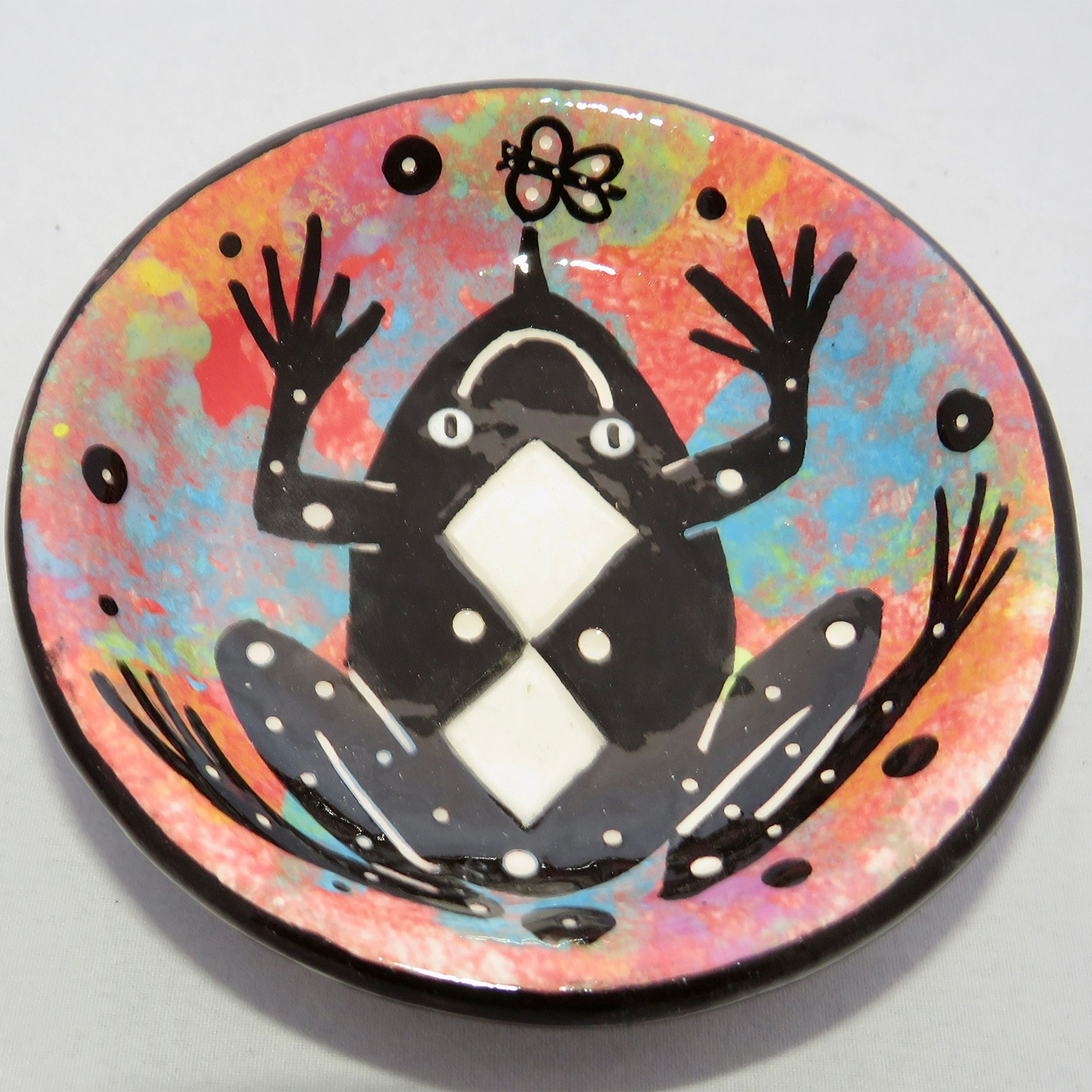 Photo of Mana Pottery Holy Bowl featuring toad on rose background, and black and white marbled underside.