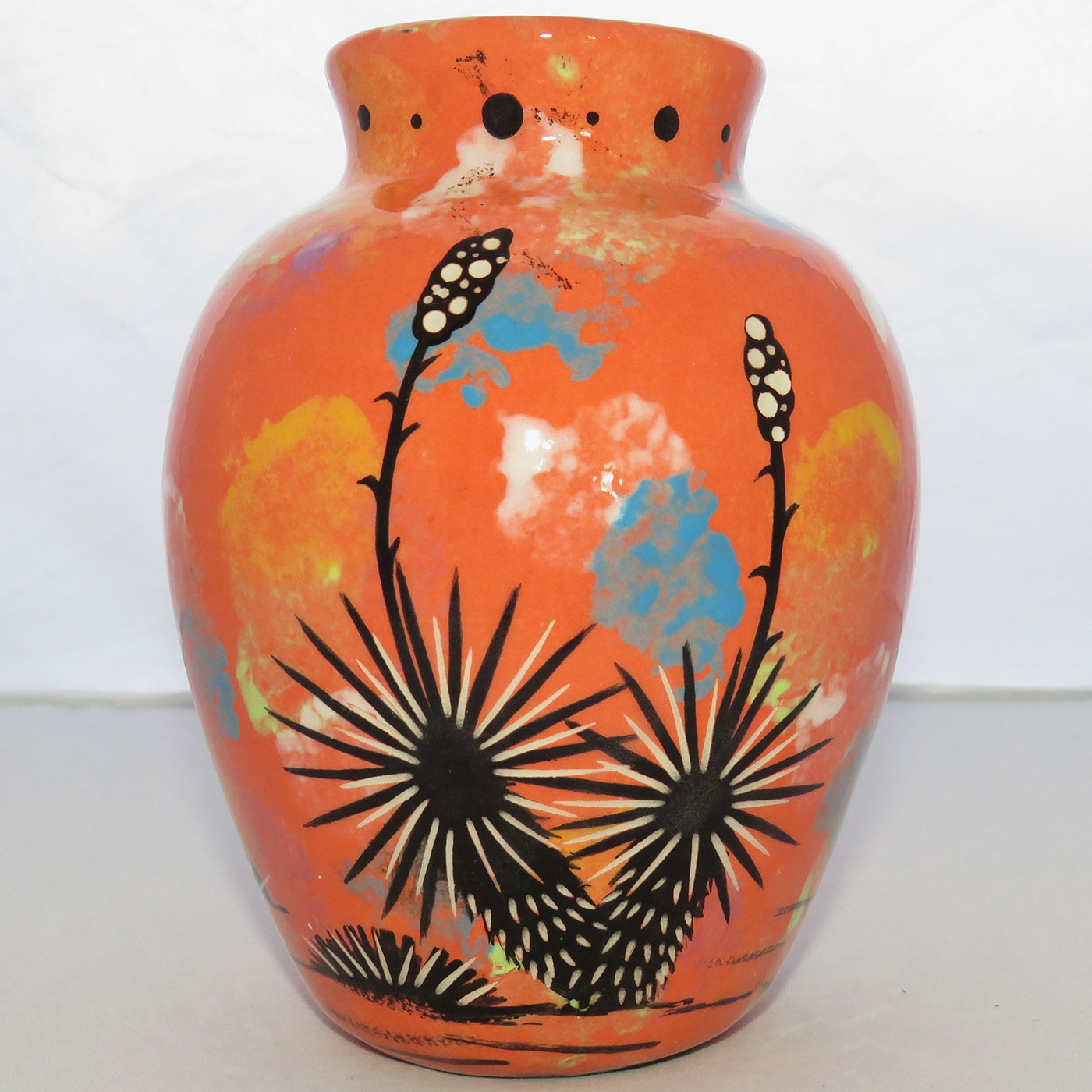 Photo of Mana Pottery Six Inch Vase featuring javelina and baby on one side and desert plants on reverse, all on a coral background.