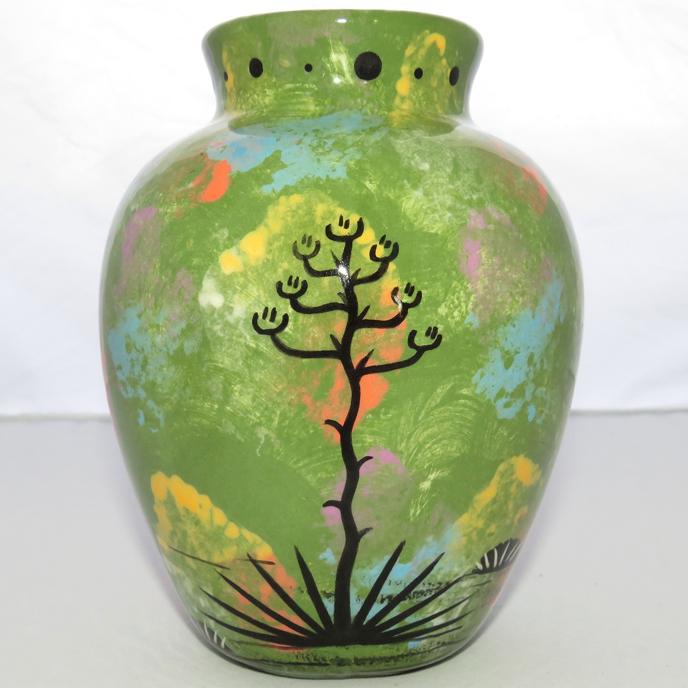 Photo of Mana Pottery Six Inch Vase featuring toad on one side and desert plants on reverse, all on a lime green background.