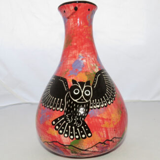 Photo of Mana Pottery Teardrop Vase featuring owl in flight over desert, on mottled rose background.