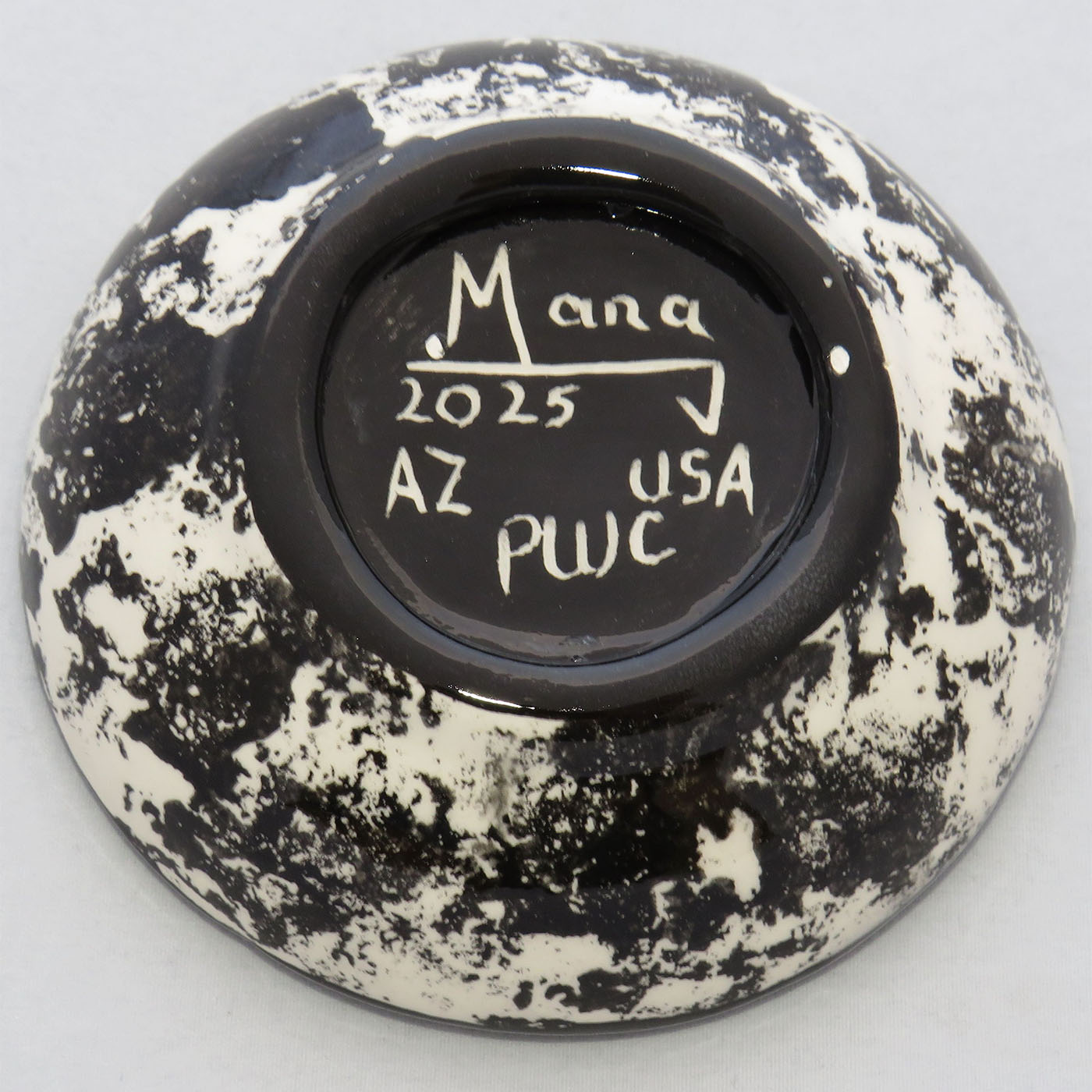 Image of Mana Pottery Holy Bowl featuring the Chakra Being on confetti style background. This view shows the black and white underside.