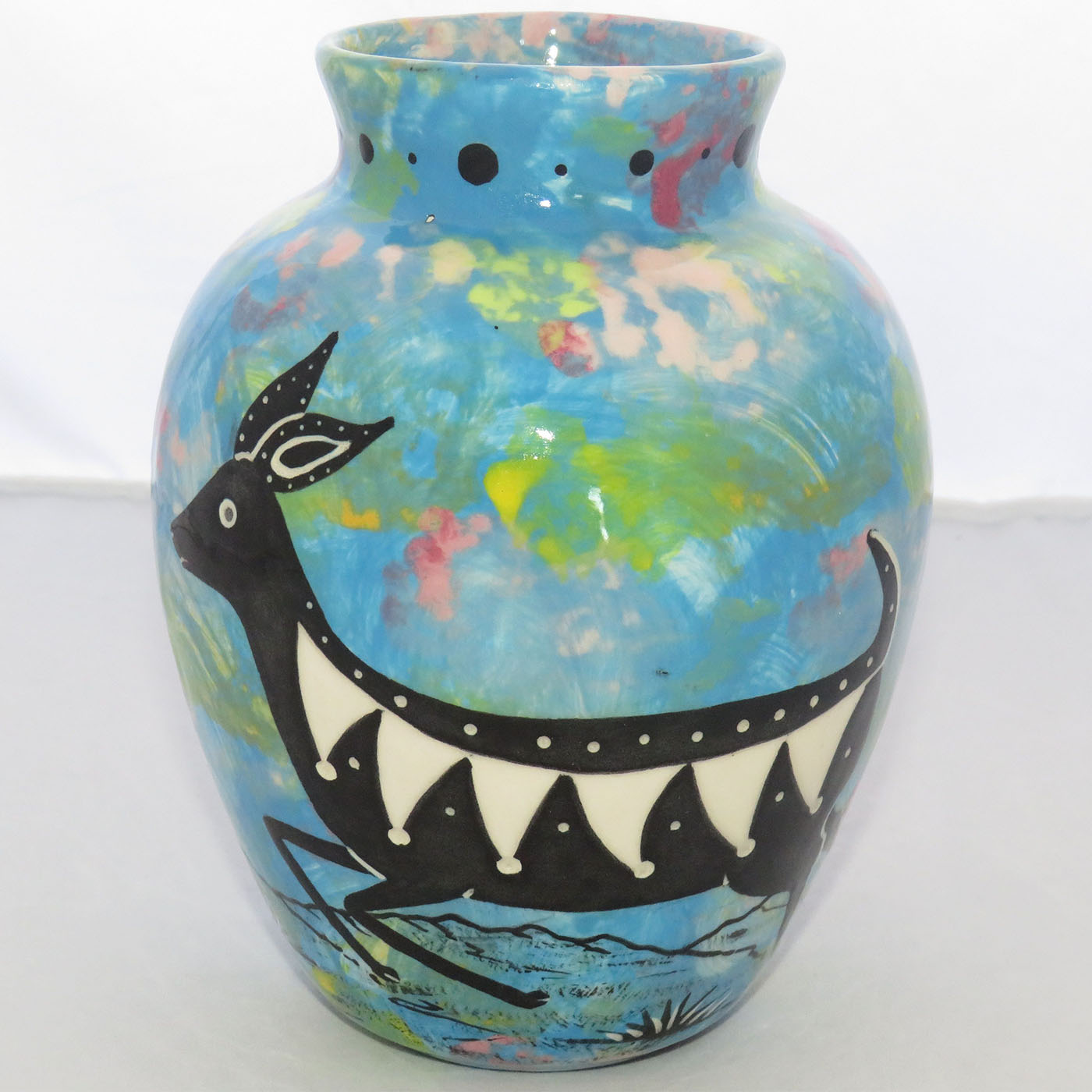 Image of Mana Pottery Six Inch Vase featuring deer running through desert on turquoise blue background.