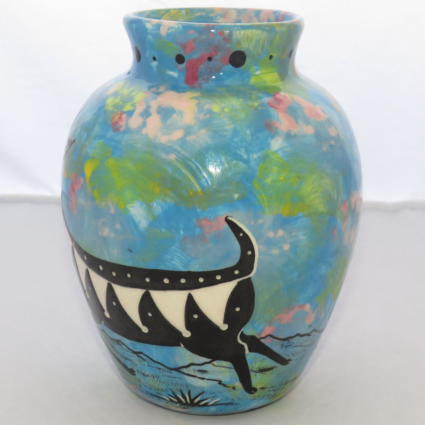 One view of Mana Pottery Six Inch Vase featuring deer running through desert on turquoise blue background.