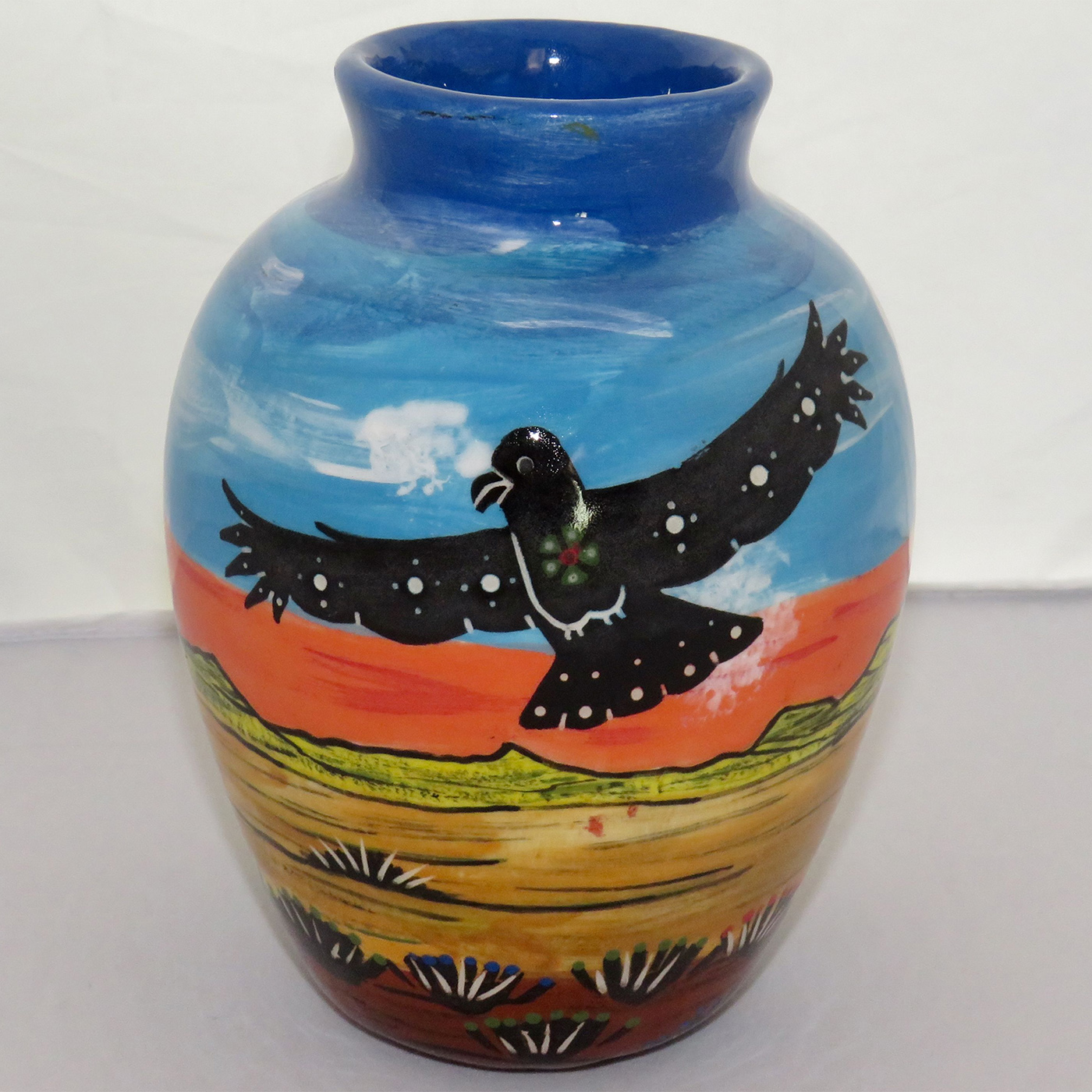 Image of Mana Pottery Six Inch Vase featuring hawk in flight on one side and howling coyote on the other, against desert and flame red sky.