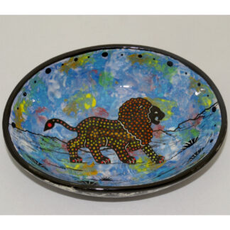 Image showing Mana Pottery Oval Bowl featuring the African lion, the King of the Jungle, on blue background, with marbled black and white underside.